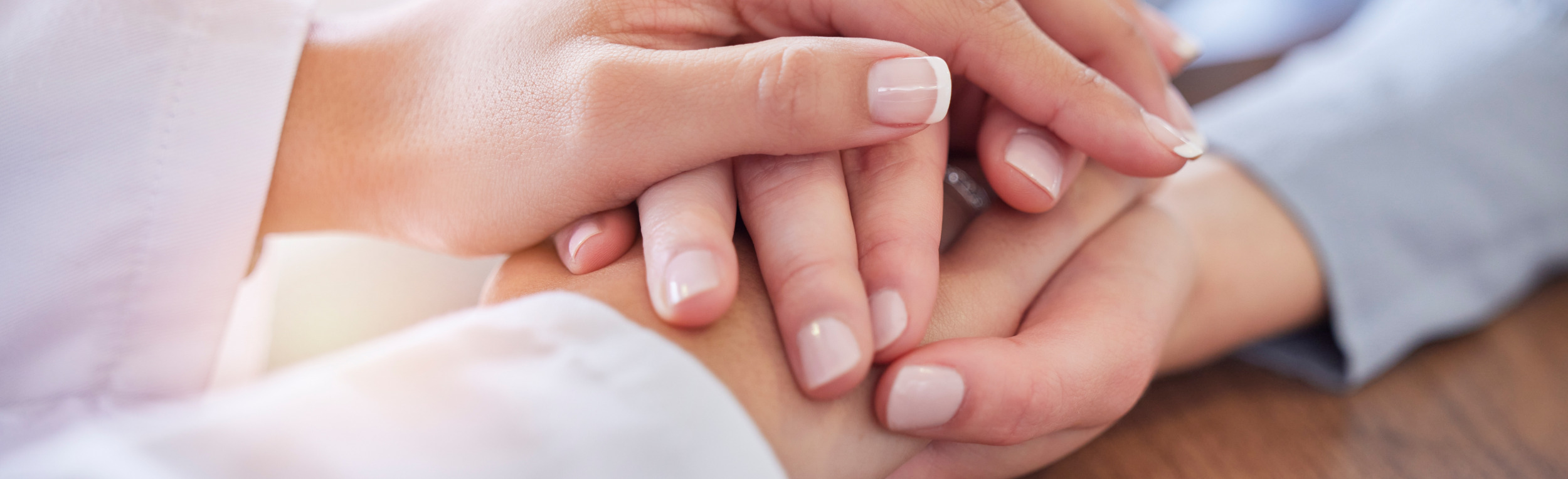 Holding,Hands,,Doctor,And,Patient,At,Desk,For,Comfort,,Talking